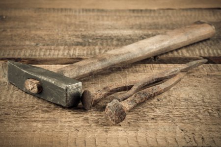 Photo for Vintage old hammer with rusty nails on wood table background - Royalty Free Image