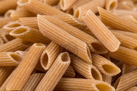 Photo for Wholemeal Pasta Penne as close-up shot for background - Royalty Free Image