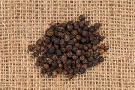 Photo for Black pepper peas on sacking material background - Royalty Free Image