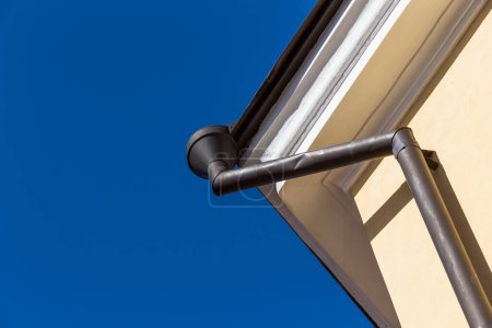 Photo for Rain gutters on old home. There is a blue sky in the background. - Royalty Free Image
