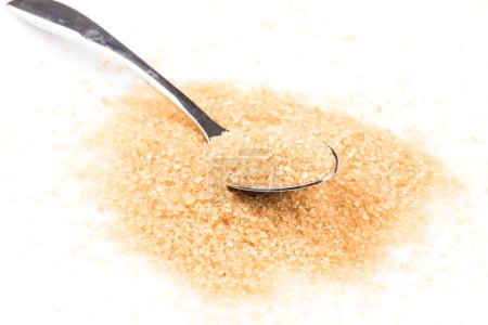 Photo for Brown sugar in a spoon on white background - Royalty Free Image