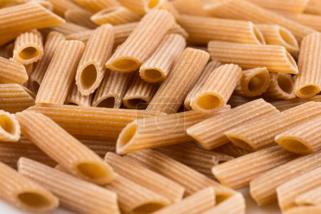 Photo for Wholemeal Pasta Penne as close-up shot for background - Royalty Free Image