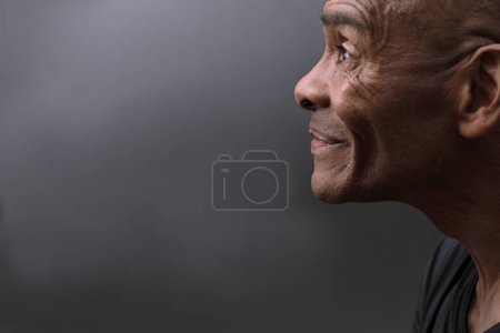 Photo for Man looking up praying to god on grey background - Royalty Free Image
