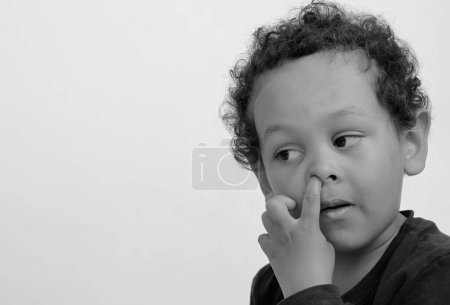 Photo for Boy picking his nose with people on white background - Royalty Free Image
