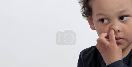 Photo for Boy picking his nose with people on white background - Royalty Free Image