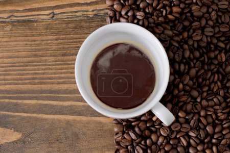 Photo for Hot roasted coffee beans and white cup - Royalty Free Image
