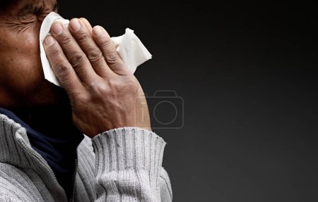 Photo for Cold and flu blowing nose after catching the flu with grey black background with people stock image stock photo - Royalty Free Image