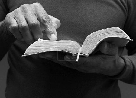 Photo for Praying to God holding Bible book - Royalty Free Image