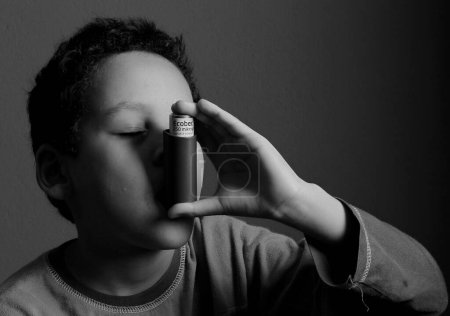 Photo for Little boy holding inhaler on studio background - Royalty Free Image