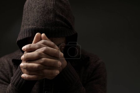 Photo for Praying to god for forgiveness Caribbean man praying  with people stock image stock photo - Royalty Free Image