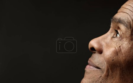 Photo for Black man praying to god Caribbean man praying with black background - Royalty Free Image