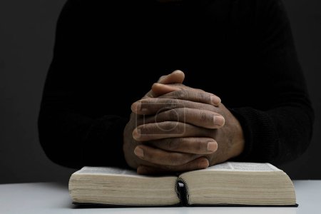 Photo for Man holding the holy bible book prying - Royalty Free Image