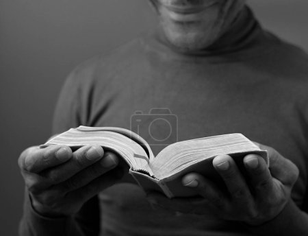 Photo for Man holding reading the holy bible - Royalty Free Image
