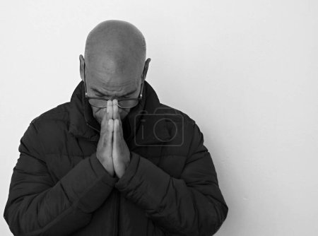 Téléchargez les photos : Priant Dieu sur fond gris noir - en image libre de droit