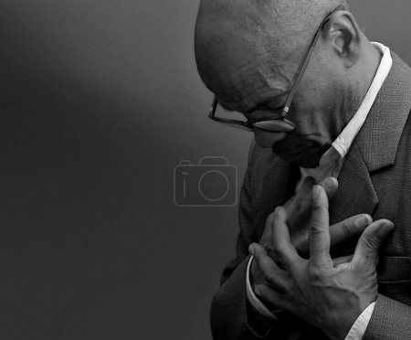 Photo for Black man praying to god with black grey background - Royalty Free Image