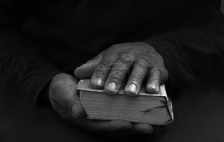 Photo for Black man praying to god with bible - Royalty Free Image