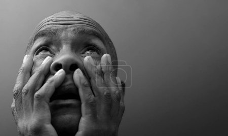 Photo for Man praying to god on grey black background - Royalty Free Image