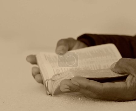 Photo for Black man people praying to God with hands together on bible - Royalty Free Image