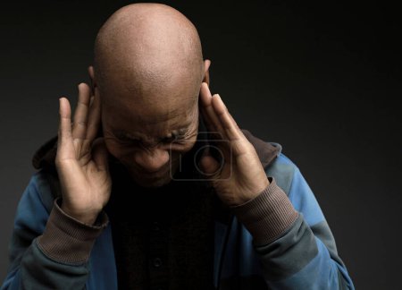 Photo for Man suffering from deafness and hearing loss on grey background - Royalty Free Image