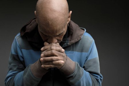 Photo for Caribbean man praying to god - Royalty Free Image