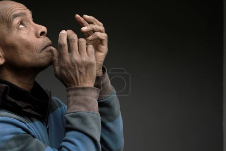 Photo for Caribbean man praying to god - Royalty Free Image