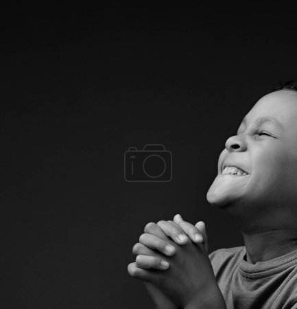 Photo for Child boy praying to God with hands together on white background - Royalty Free Image