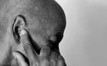 Photo for Deaf man suffering from deafness and hearing loss. Black and white image - Royalty Free Image