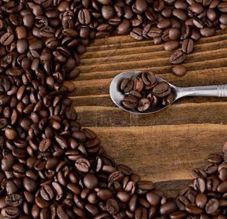 Foto de Cuchara de metal en forma de corazón hecha de granos de café - Imagen libre de derechos