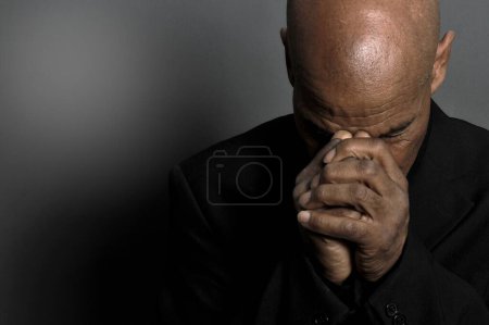 Foto de Hombre rezando a Dios sobre fondo negro - Imagen libre de derechos