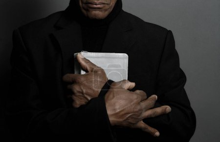 Photo for Man praying to God on black background - Royalty Free Image