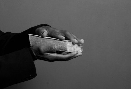 Photo for Man praying to god with bible in the hands, close up - Royalty Free Image