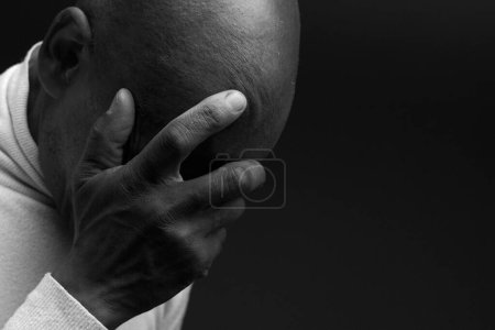 Photo for Man praying to god with hands on black background - Royalty Free Image