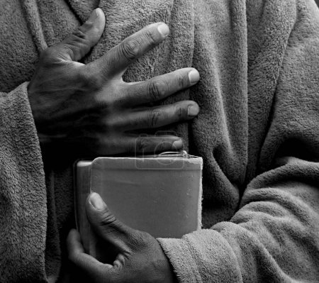 Photo for Man praying to god with bible in the hands, close up - Royalty Free Image