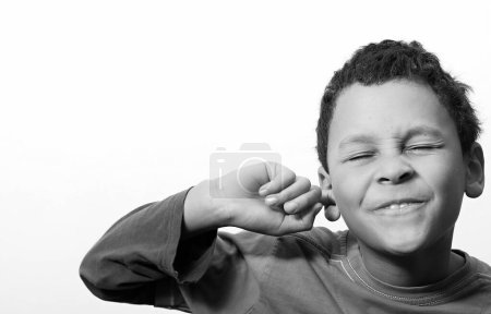 little deaf boy covering his ears on white background