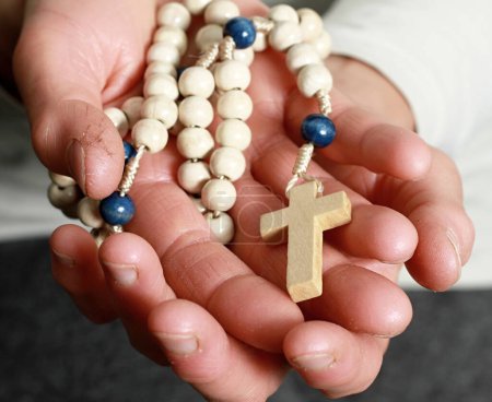 Photo for Closeup view of rosary in hands, religion conceptual photo - Royalty Free Image