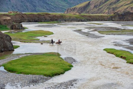 Deux cavaliers traversant une rivière, vallée de Kurumduk, province de Naryn, Kirghizistan, Asie