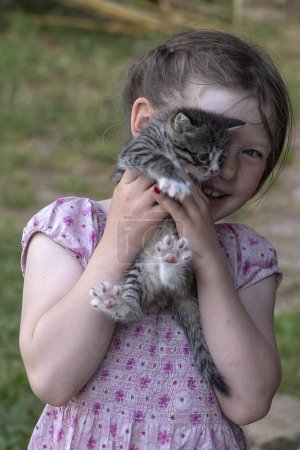 Little girl, 5 years, with a little cat on her arm, Germany, Europe