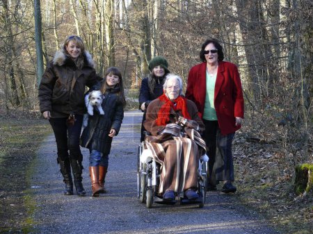 Great-grandmother with daughter, 4 generations, 95 years old woman in wheelchair with descendants