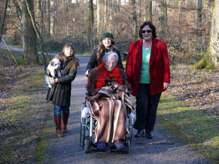 Great-grandmother with daughter, 3 generations, 95 years old allte woman in wheelchair with descendants