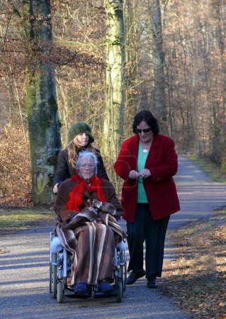 Great-grandmother with daughter, 3 generations, 95 years old allte woman in wheelchair with descendants