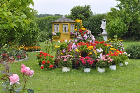Pyramid of flowers in the garden, gazebo in the garden