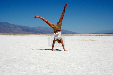 A tourist does a cartwheel in Death Valley, California, USA, North America