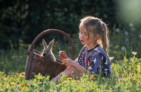 Girl with hare in meadow