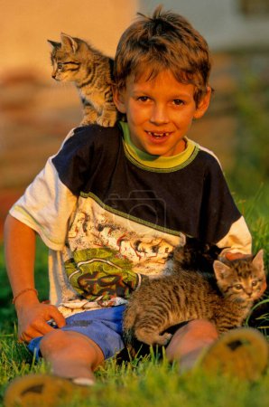 Boy with young house cats
