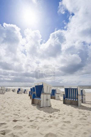 Roofed wicker beach chairs on the beach in Westerland, Germany, Europe
