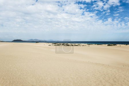 Dunes against blue sea, Corralejo Dunes Natural Park, Corralejo, Fuerteventura, Canary Islands, Spain, Europe