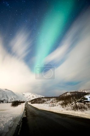 Northern lights over road with snow mountains, near Troms, Troms, Norway, Europe 