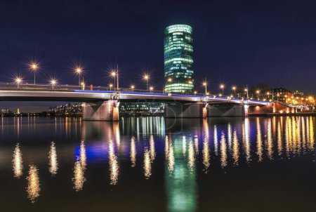 View of Friedensbrcke with Westhafen Tower, reflection of the lights in the Main, Schaumainkai, Frankfurt am Main