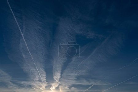 Several condensation trails in the blue sky