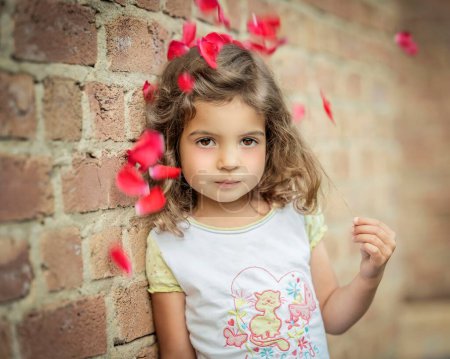 Girl, 3 years old, leans against a wall under flowers, Portrait, Germany, Europe